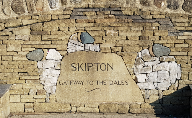 Sign carved into stone reading 'Skipton, Gateway to the Dales'
